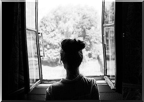 woman looking through open window