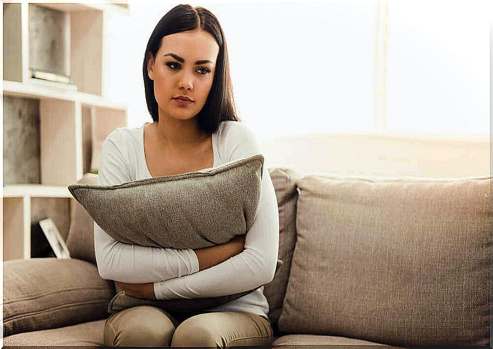 sad woman hugging pillow