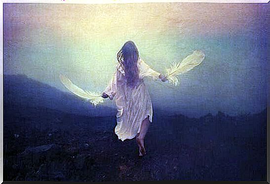 Woman running with feathers in her hands.