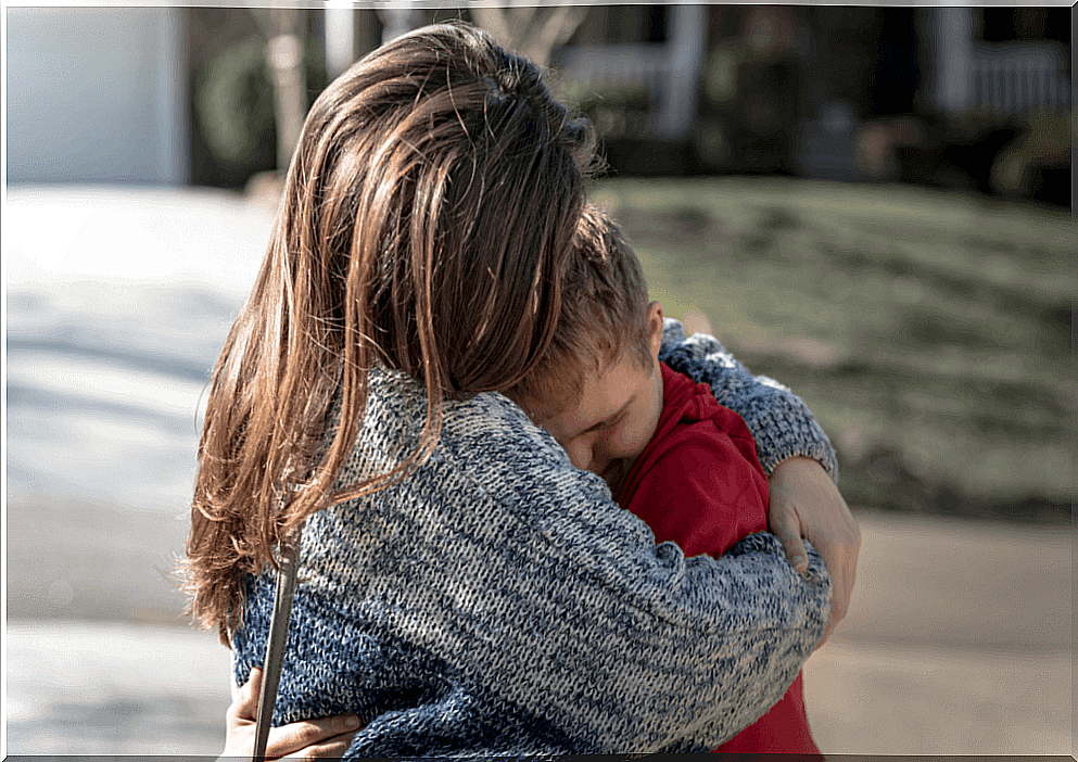 mother hugging disabled child