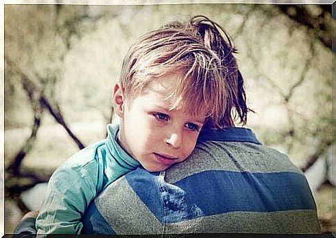 Boy with low self-esteem hugging his father