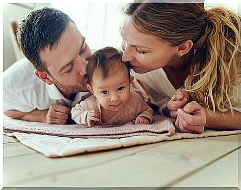 parents kissing their baby son