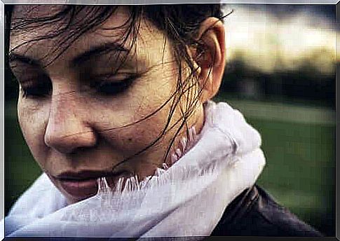 Woman with her hair in the wind thinking about happiness.