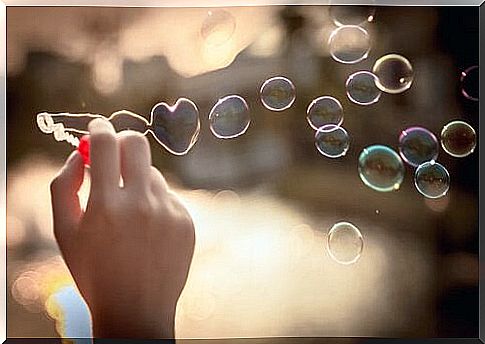 person making soap bubbles