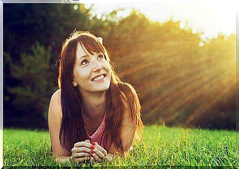 happy woman lying in the grass